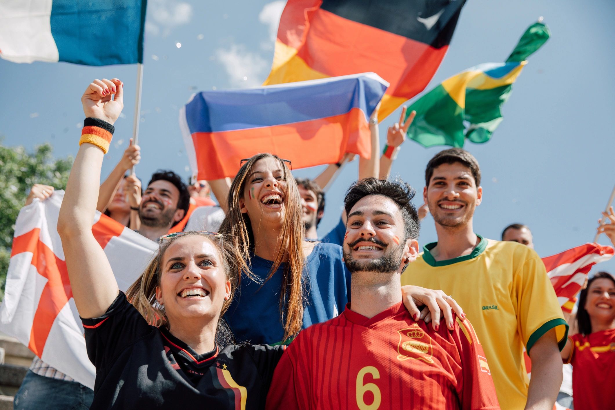 Supporters smiling together with national flags